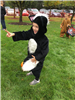 A child in a skunk costume