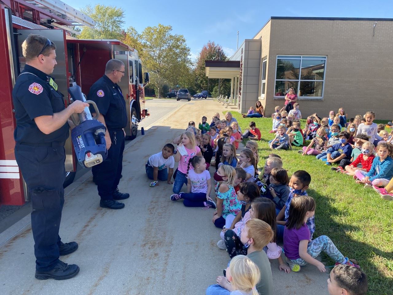 Firefighter talking to group of kids