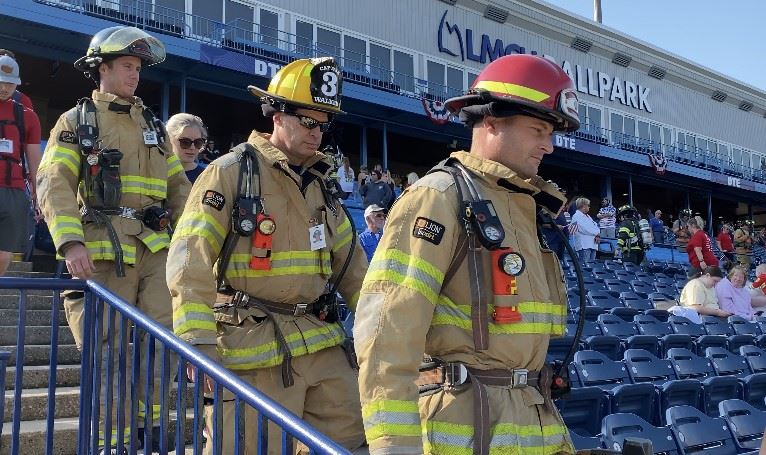 Firefighters walking down stadium stairs