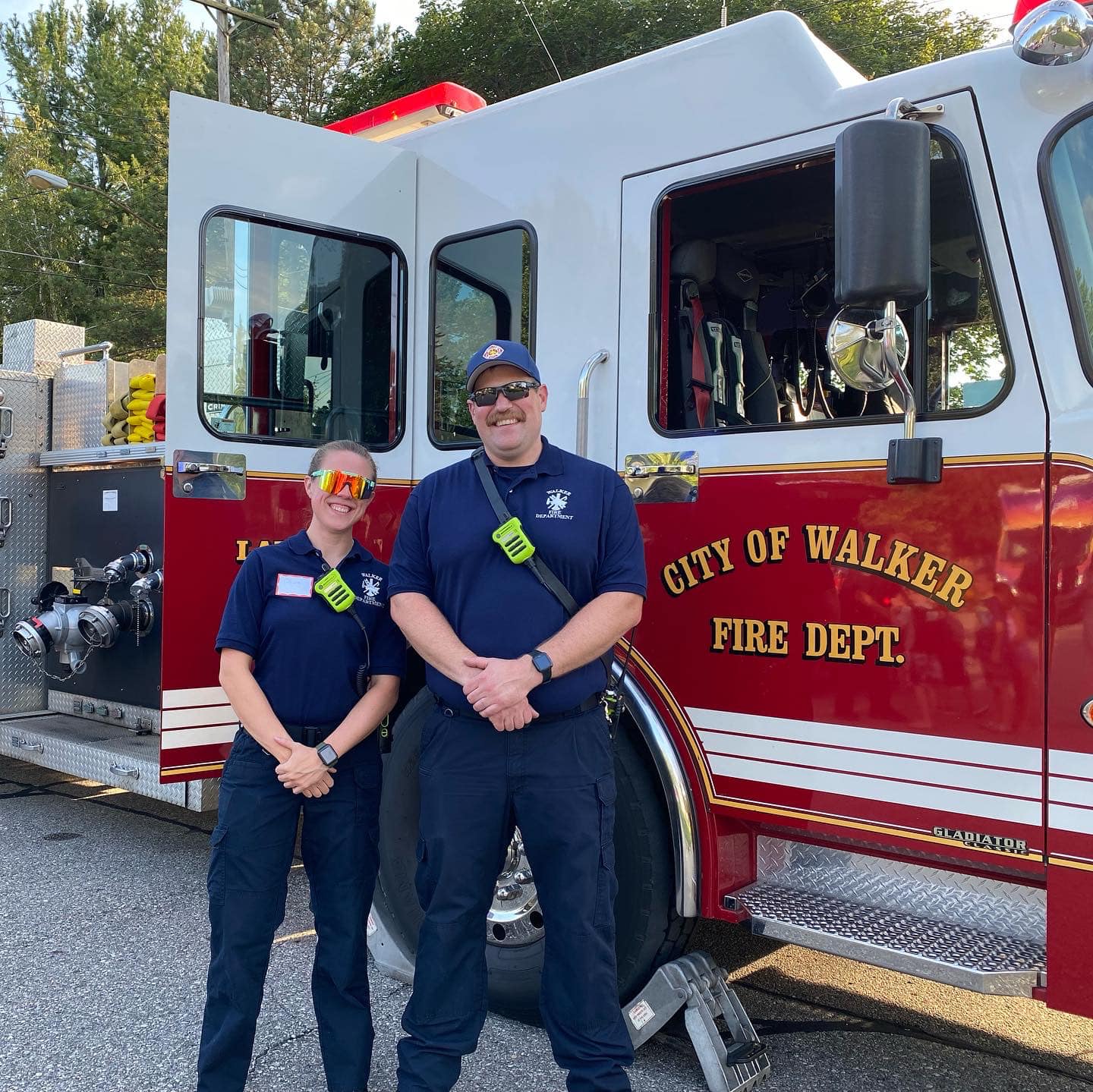 Firefighters standing next to fire truck