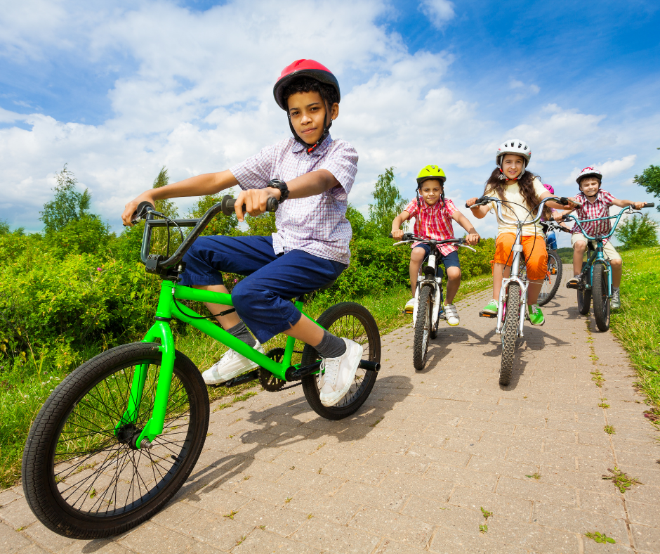 kids in helmets riding bikes