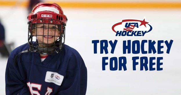 Young boy smiling while wearing hockey gear. He is standing on an ice rink.