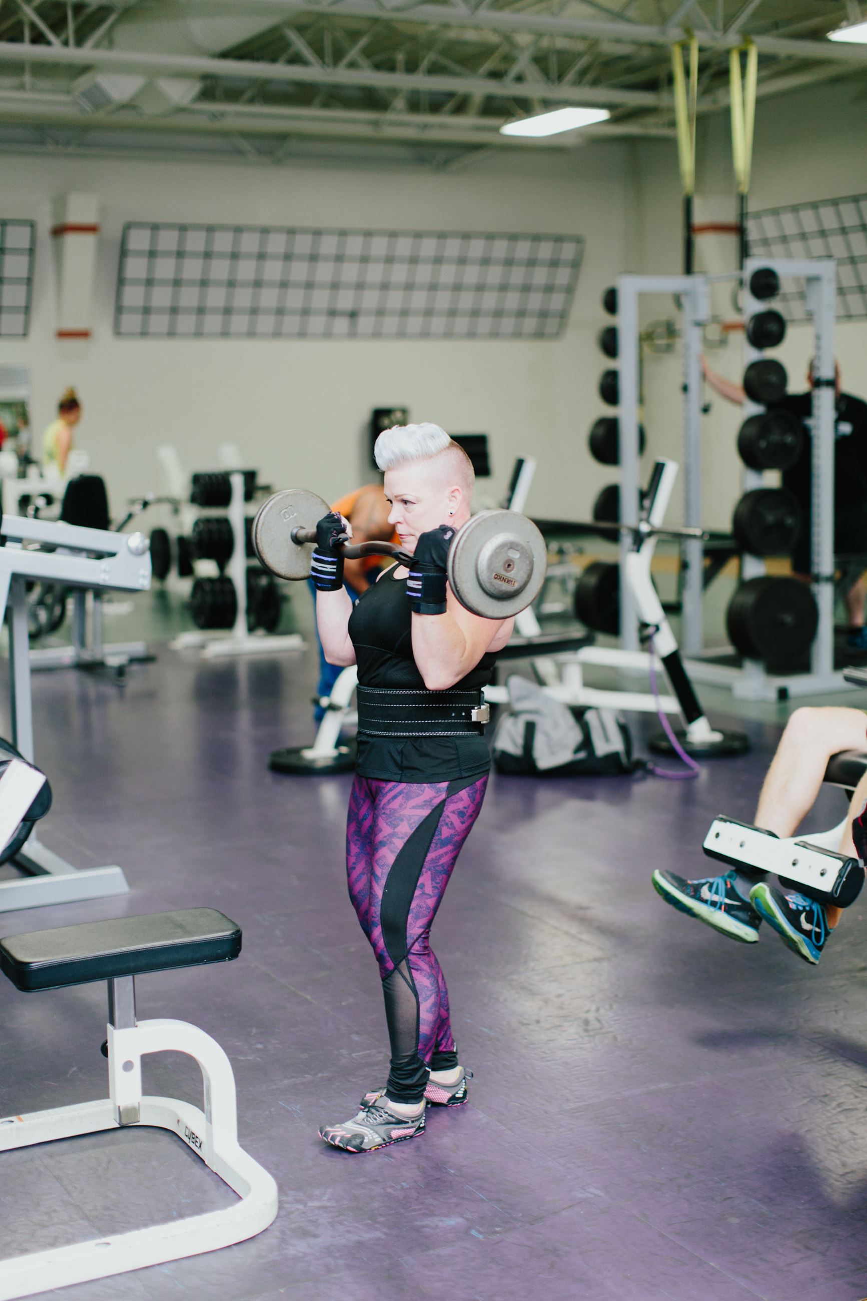 Gym member doing bicep curls