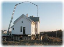 The house being steadied by a crane
